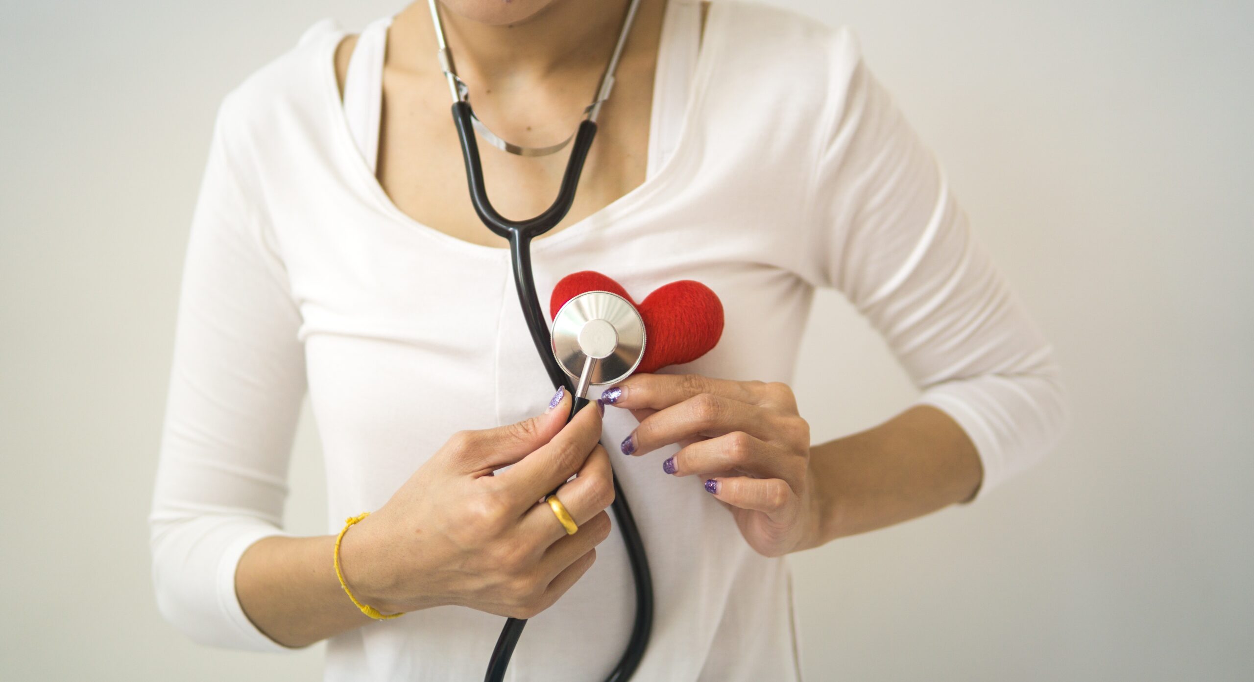 type 2 diabetic holding a stethoscope to her heart